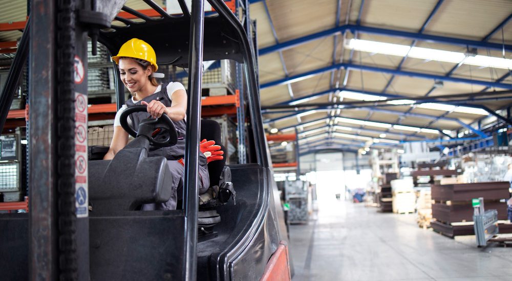 professional-female-industrial-driver-operating-forklift-machine-factory-s-warehouse