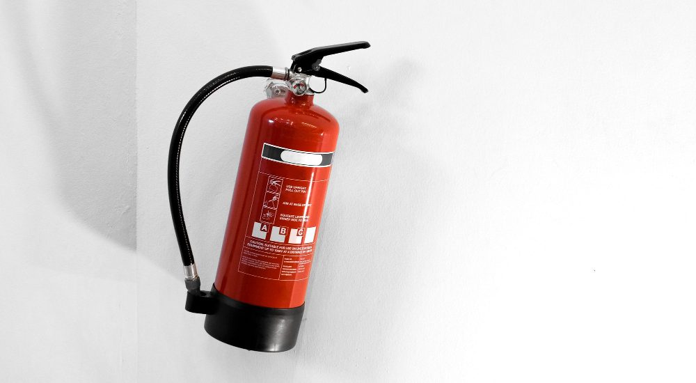 red-fire-extinguisher-white-wall